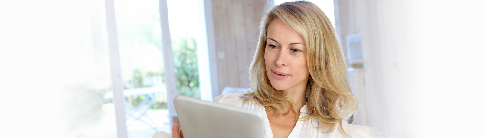 Woman using her tablet and looking interested