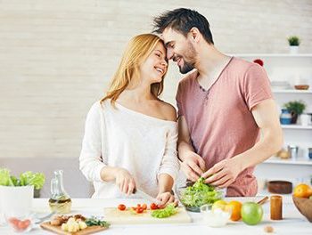 Couple cooking vegetables together