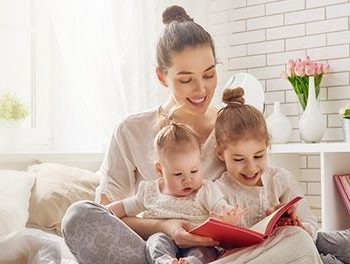 Young mother reading to her babies