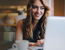 Woman using her laptop in a cafe