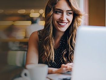 Woman using her laptop in a cafe