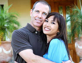 Happy caucasian man and Chinese woman hugging