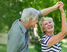 Happy couple dancing in the park