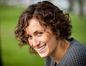 curly headed older woman smiling 