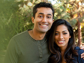 Sweet young Indian couple hugging each other outside