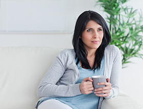 woman sitting on sofa and thinking