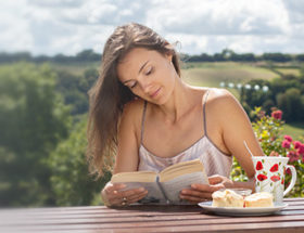 beautiful woman reading a book outside