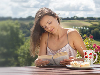 beautiful woman reading a book outside