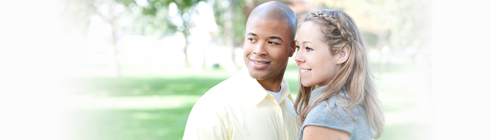 Smiling interracial couple in the park