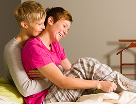 Two women hugging in their pajamas