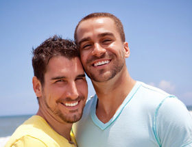 happy gay couple at the beach