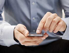 Close up of male hands using a smart phone