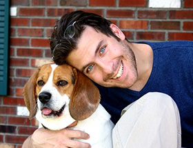 Handsome blue eyed man with cute dog