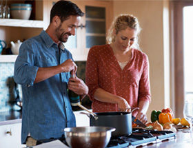 mid-30s couple cooking together