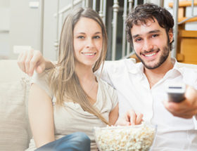 Happy couple binge watching television